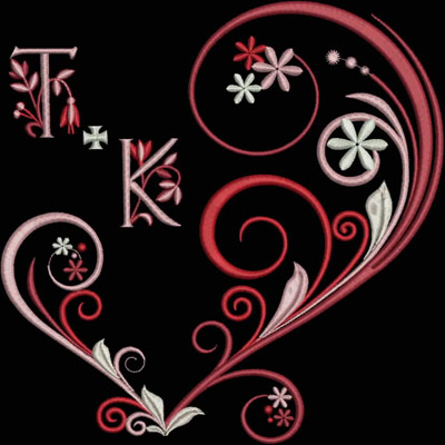 An embroidery design of an ornate heart shape featuring stylized initials "T" and "K," embellished with floral motifs and swirling patterns in shades of red and pink.