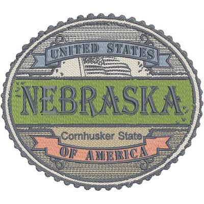 An embroidery design of a circular patch featuring the word "NEBRASKA," with the phrases "United States" and "Cornhusker State" prominently displayed in decorative lettering.