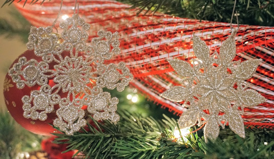 An embroidery design of intricate golden snowflakes, showcasing delicate floral patterns and textures.