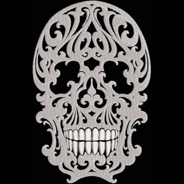 An embroidery design of a detailed skull adorned with intricate scrollwork and floral motifs.