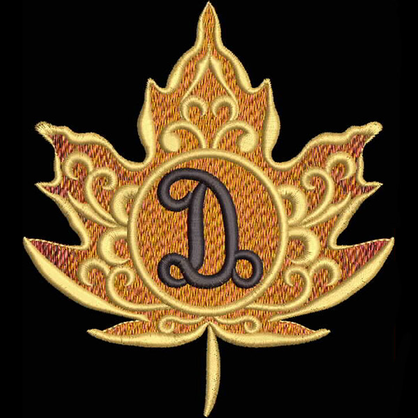 An embroidery design of a stylized autumn leaf in shades of orange and gold, featuring an ornate letter "D" in the center.
