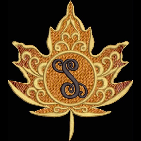 An embroidery design of an intricate golden maple leaf with a stylized letter "S" in the center.