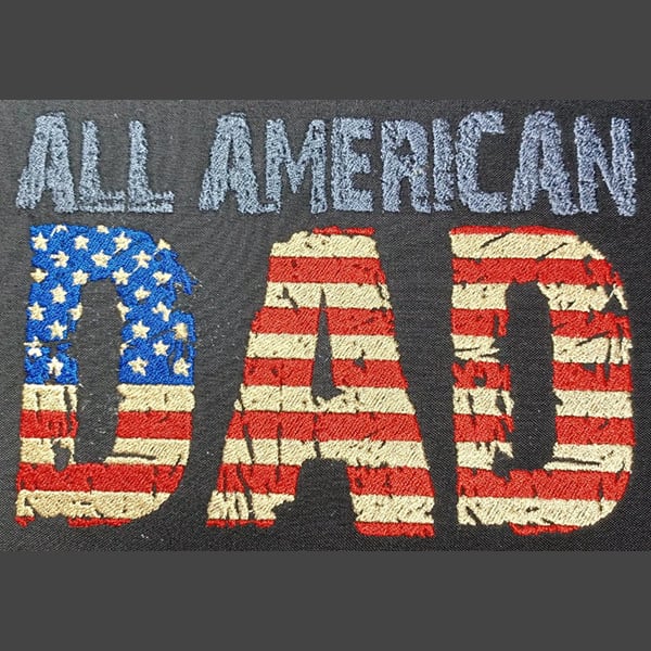 An embroidery design of the words "ALL AMERICAN DAD" in a patriotic style featuring red, white, and blue elements resembling the American flag.