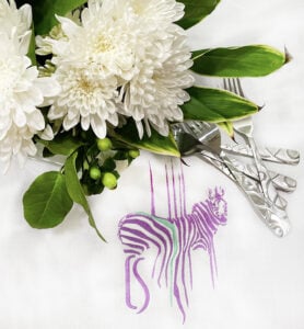 An embroidery design of a stylized zebra featuring vibrant stripes in purple and green.